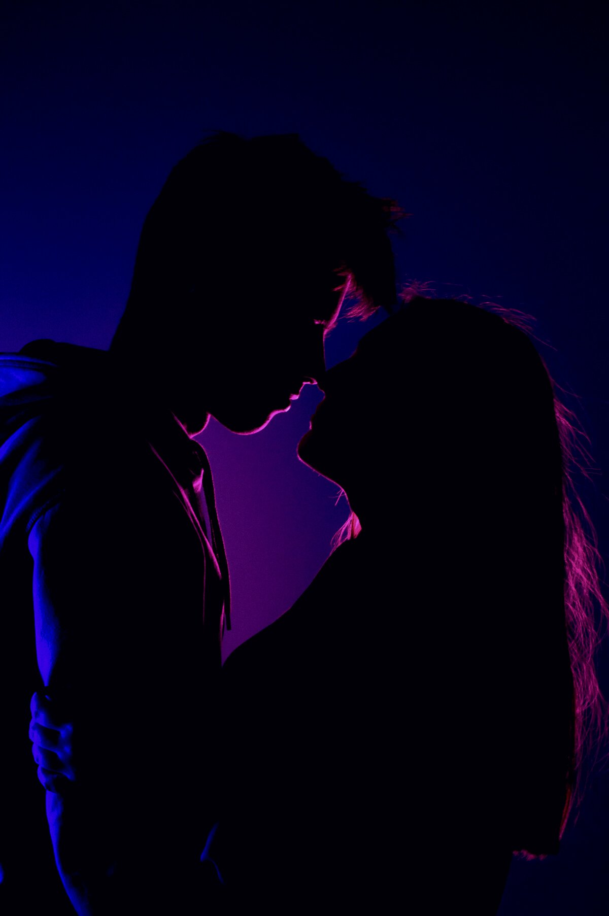 Man and Woman Kissing during Night Time