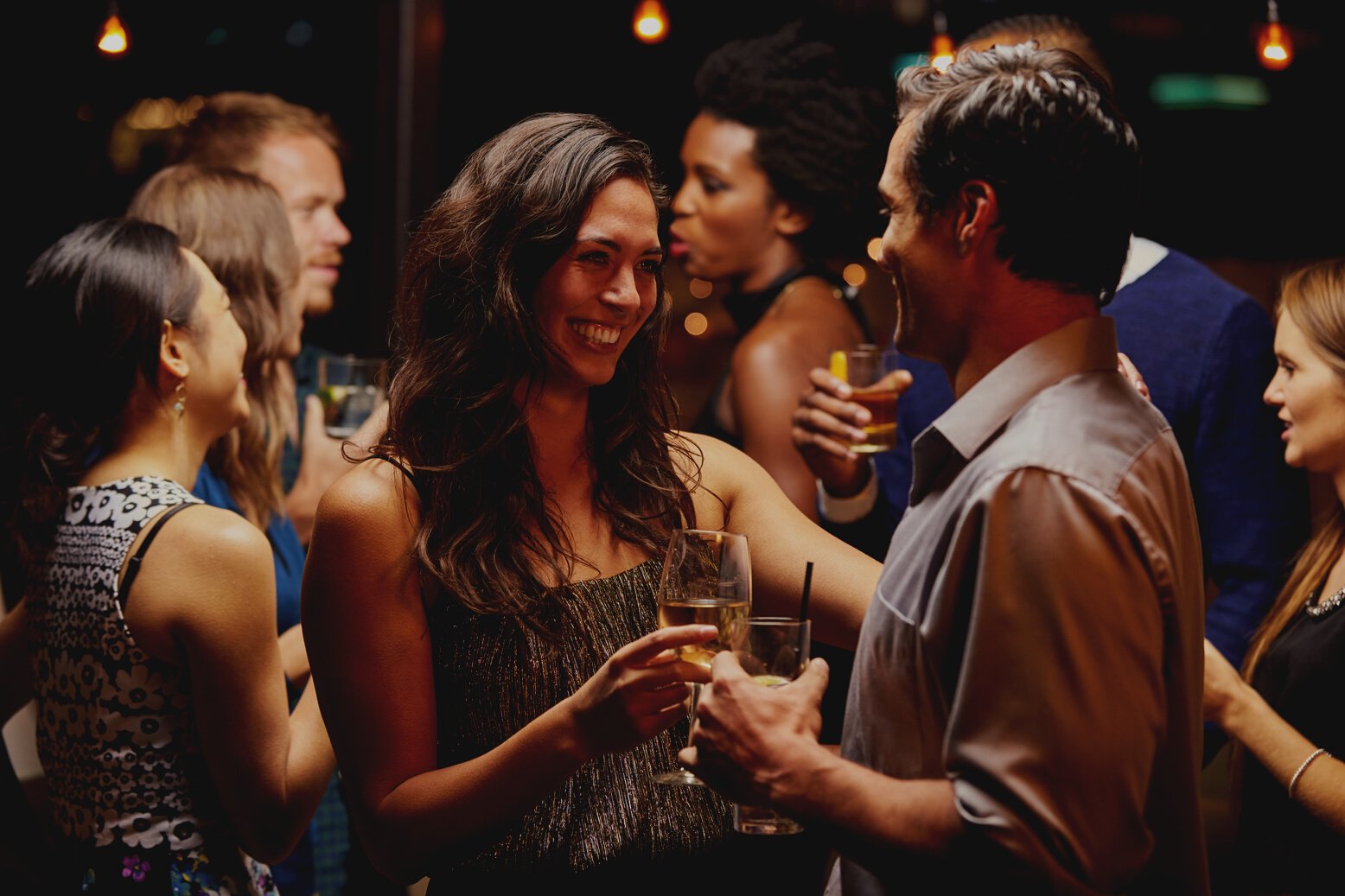 Couples Dancing and Drinking at Evening Party